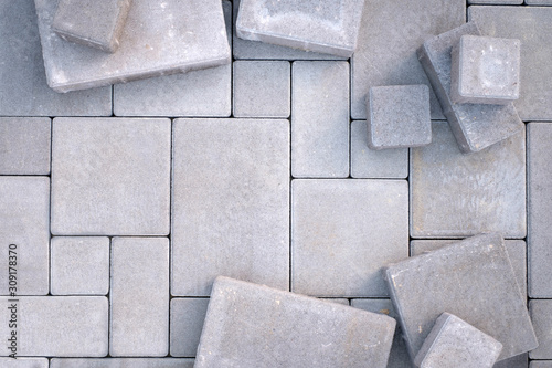 Fototapeta Laying gray concrete paving stones on house courtyard