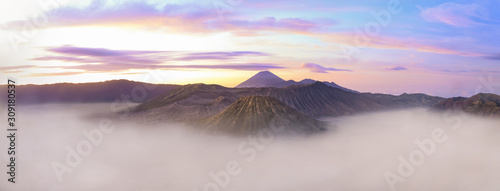 View from above  stunning panoramic view of the Mount Semeru  Mount bromo and the Mount Batok surrounded by clouds during a beautiful sunrise. East Java  Indonesia.