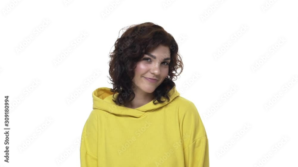 Coquettish and flirty curly girl in hoodie, glancing camera, smiling silly and feminine gaze from down to camera, acting modest or shy, flirting with someone, express affection and love interest Coquettish and flirty curly girl in hoodie, glancing camera, smiling silly and feminine gaze from down to camera, acting modest or shy, flirting with someone, express affection and love interest