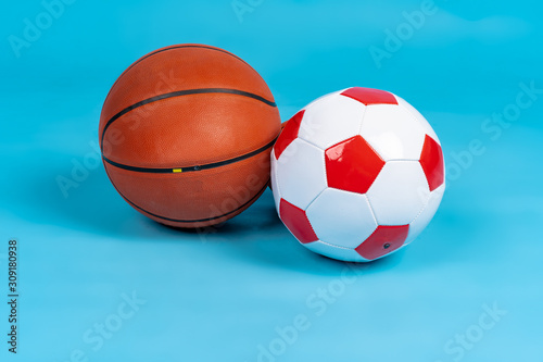 Basketball and soccer balls on a blue background