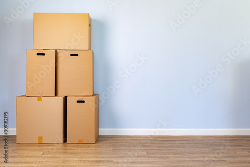 House moving concept with stacked cardboard boxes in a room