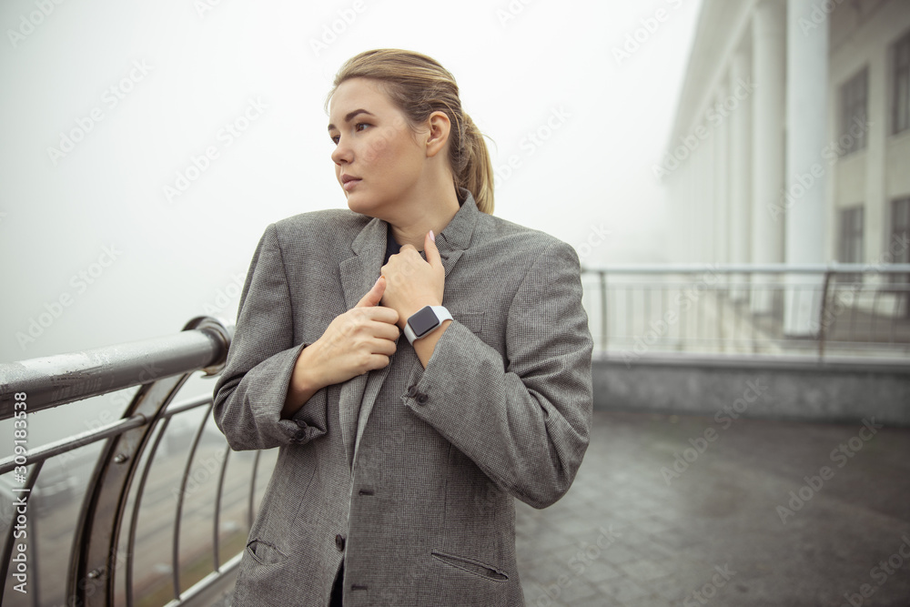 Beautiful elegant woman standing on the balcony Beautiful elegant woman standing on the balcony