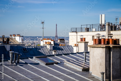 The traditional roofs of paris and the eiffel tower
