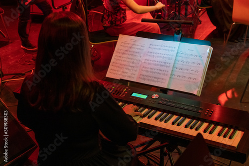 Man playing digital piano at the concert photo