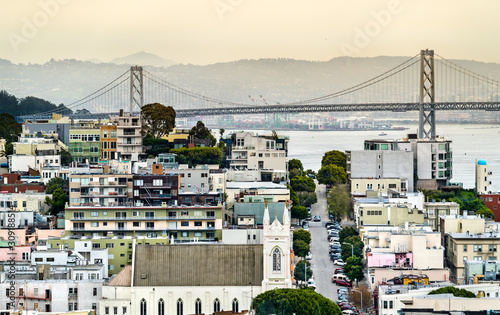 The Bay Bridge and the National Shrine of St. Francis of Assisi in San Francisco, California photo