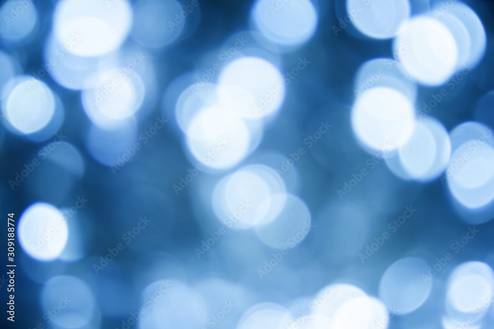 Fototapeta premium Blurred christmas lights classic blue background. Abstract bokeh with soft light. Shiny festive texture