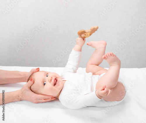 Little baby receiving osteopathic treatment of head and neck photo