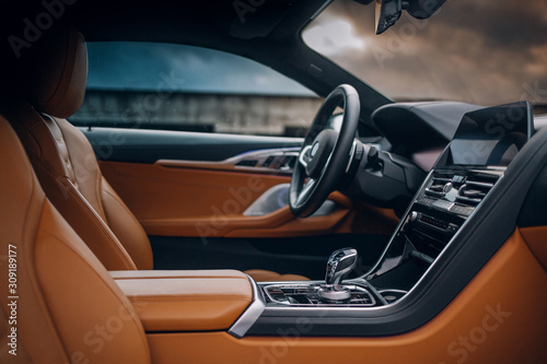 Modern supercar interior with leather panel, multimedia and dashboard © Moose