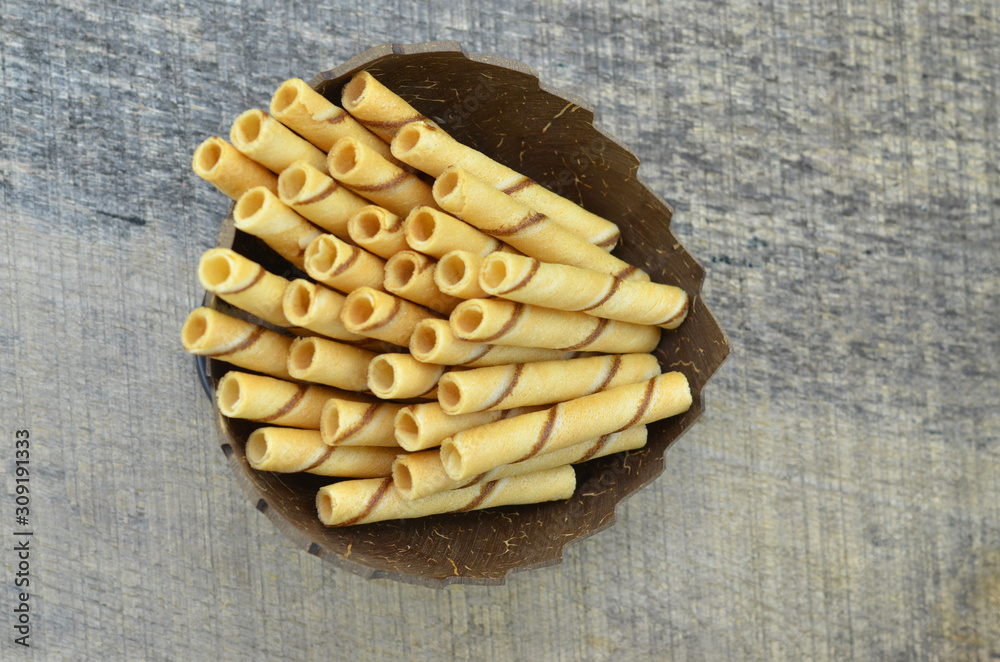Vanillia waffle roll stick in bowl wooden