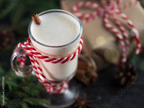 Christmas drink eggnog in a glass on the holiday table