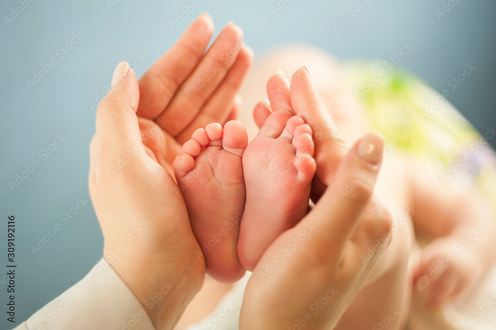 Mother love Mother holding her little baby's feet, close up.Concept skin examination by a doctor Mother love Mother holding her little baby's feet, close up.Concept skin examination by a doctor