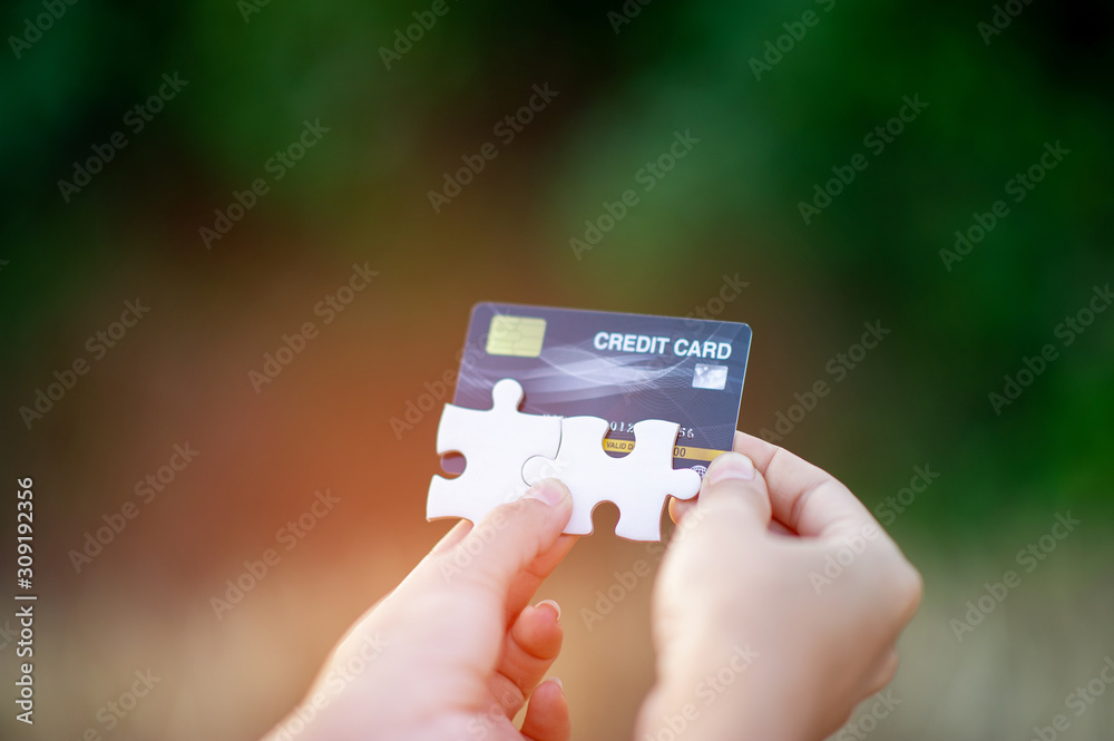 Hand and credit cards, online business operations, and cashless purchases Credit card ideas for shopping Hand and credit cards, online business operations, and cashless purchases Credit card ideas for shopping