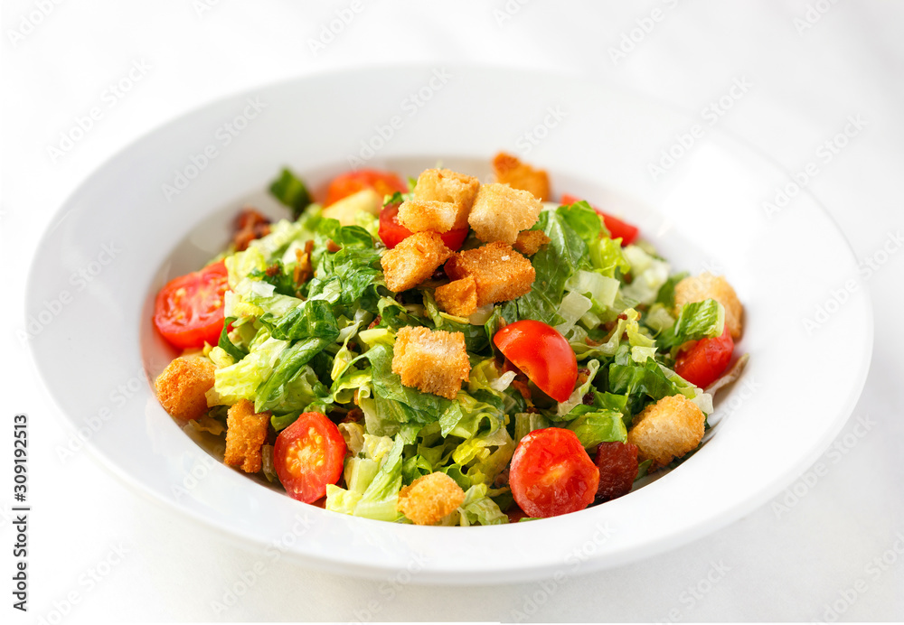Fresh garden salad with croutons on a white background Fresh garden salad with croutons on a white background