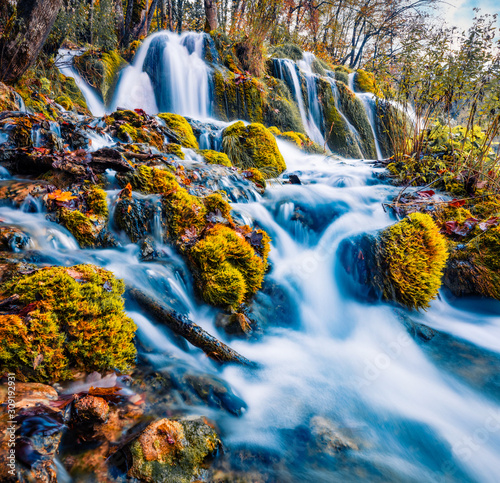 Аabulous morning view of pure water waterfall in Plitvice National Park. Mystical autumn scene of Croatia, Europe. Beauty of nature concept background. photo