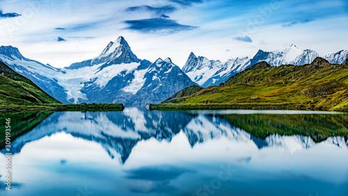 Panoramic summer view of Bachalpsee lake with Schreckhorn and Wetterhorn peaks on background. Gloomy outdoor scene of Swiss Bernese Alps, Switzerland, Europe. © Andrew Mayovskyy