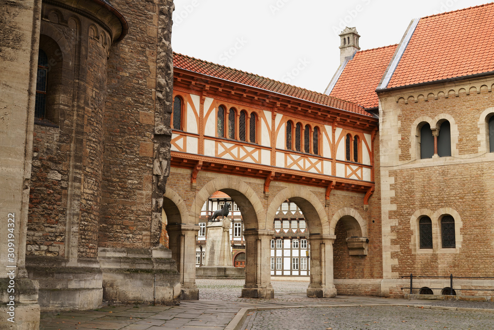 Historic old town of Brunswick, Lower Saxony in Germany. Castle Square seen through the archways of the castle and Brunswick Lion statue.