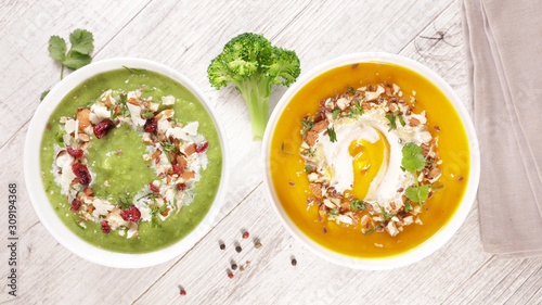 broccoli soup and pumpkin soup with cream and nuts in bowl