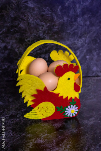 Easter eggs in the nest on rustic wooden background