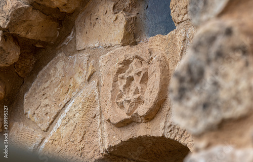 Fototapeta Star of David carved from stone over the entrance to the Jewish part of the tomb