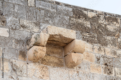 The part of the minaret outer wall located on the territory of the grave of the prophet Samuel rises above the remnant wall of the crusader fortress of Mount of Joy near Jerusalem in Israel