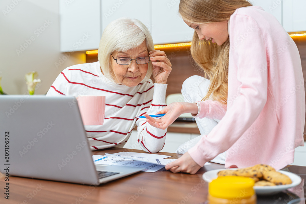 Focused elderly lady leaning over the document