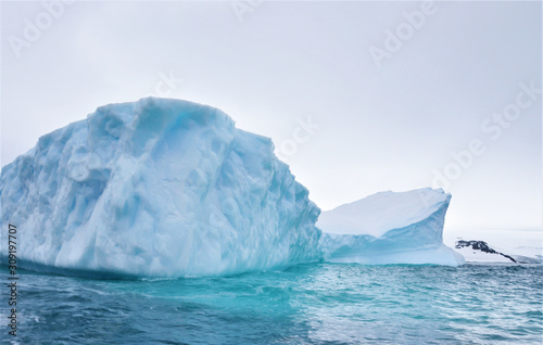 View of Icebergs. Large blocks of ice floating in the Antarctic Sea at summer, next to Carlini Base, Argentina. Global warming and climate change concept. © SilviaCZaninovich