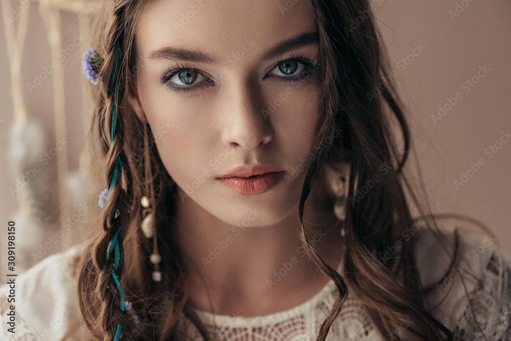 beautiful tender girl with braids in white boho dress on beige