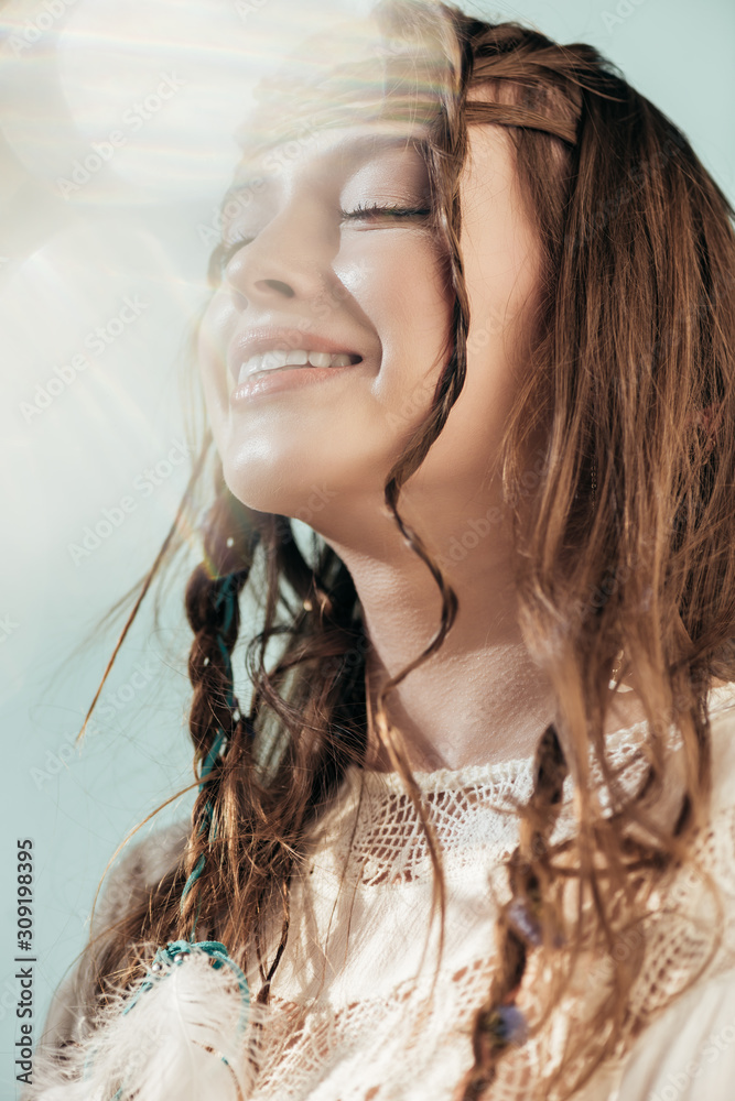 happy bohemian girl with braids in hairstyle posing in white boho dress on  grey with lens flares Stock Photo | Adobe Stock