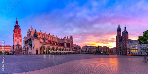 Panorama of Medieval Main market square with Basilica of Saint Mary, Cloth Hall and Town Hall Tower in Old Town of Krakow at sunrise, Poland