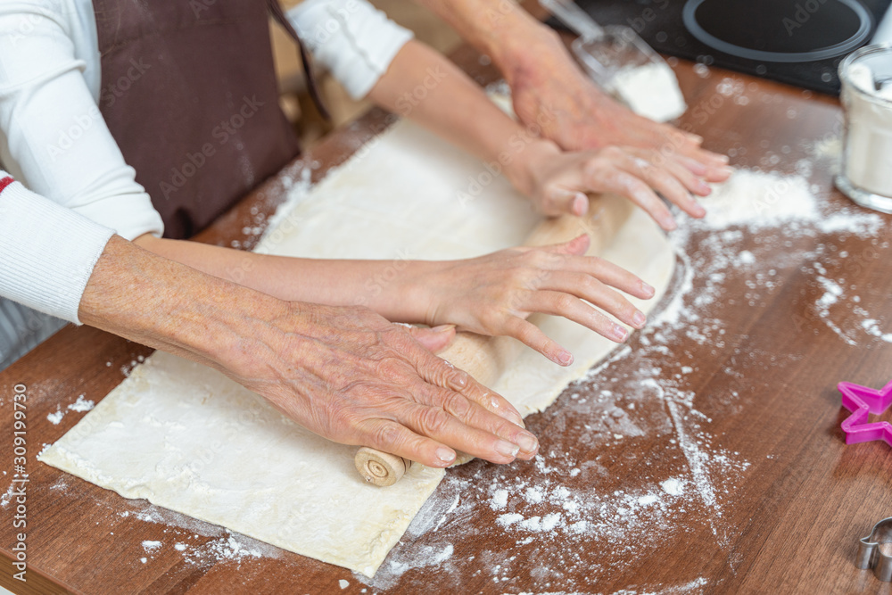 Female hands resting on the rolling pin