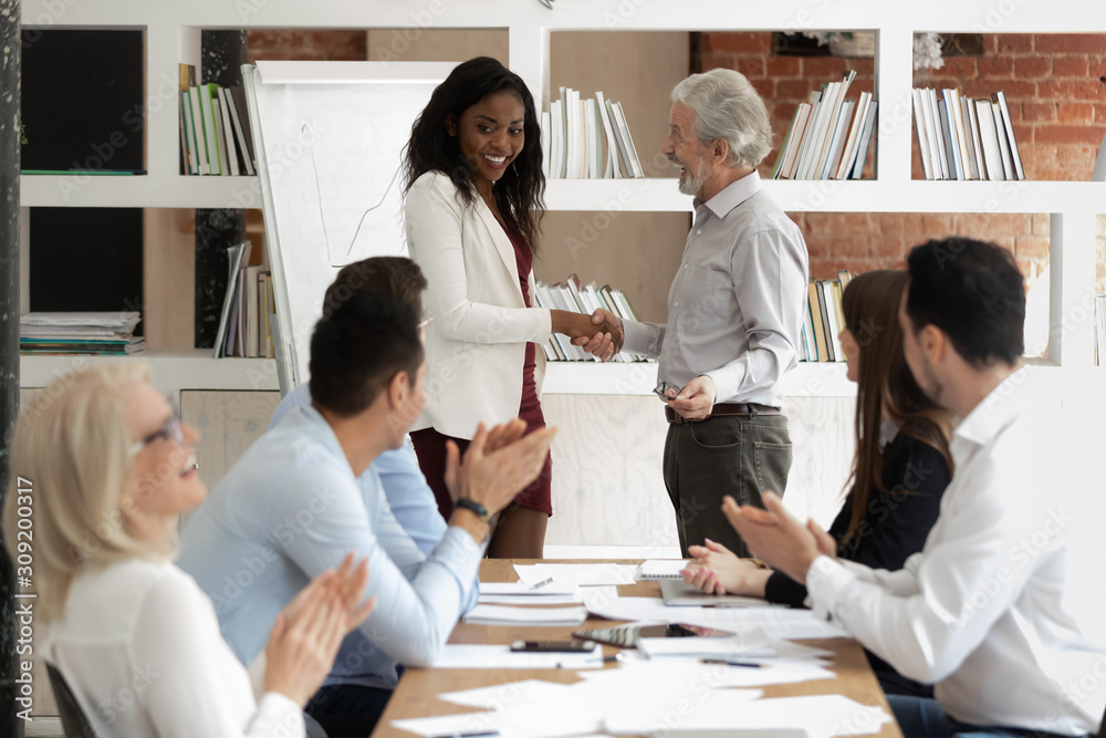 Fototapeta premium Before starting training boss presenting african coach to diverse staff