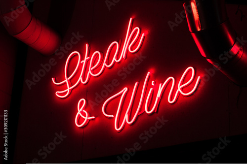 Neon inscription on a cafe in the city