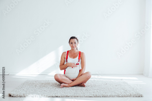 a pregnant woman is engaged in gymnastics and yoga photo