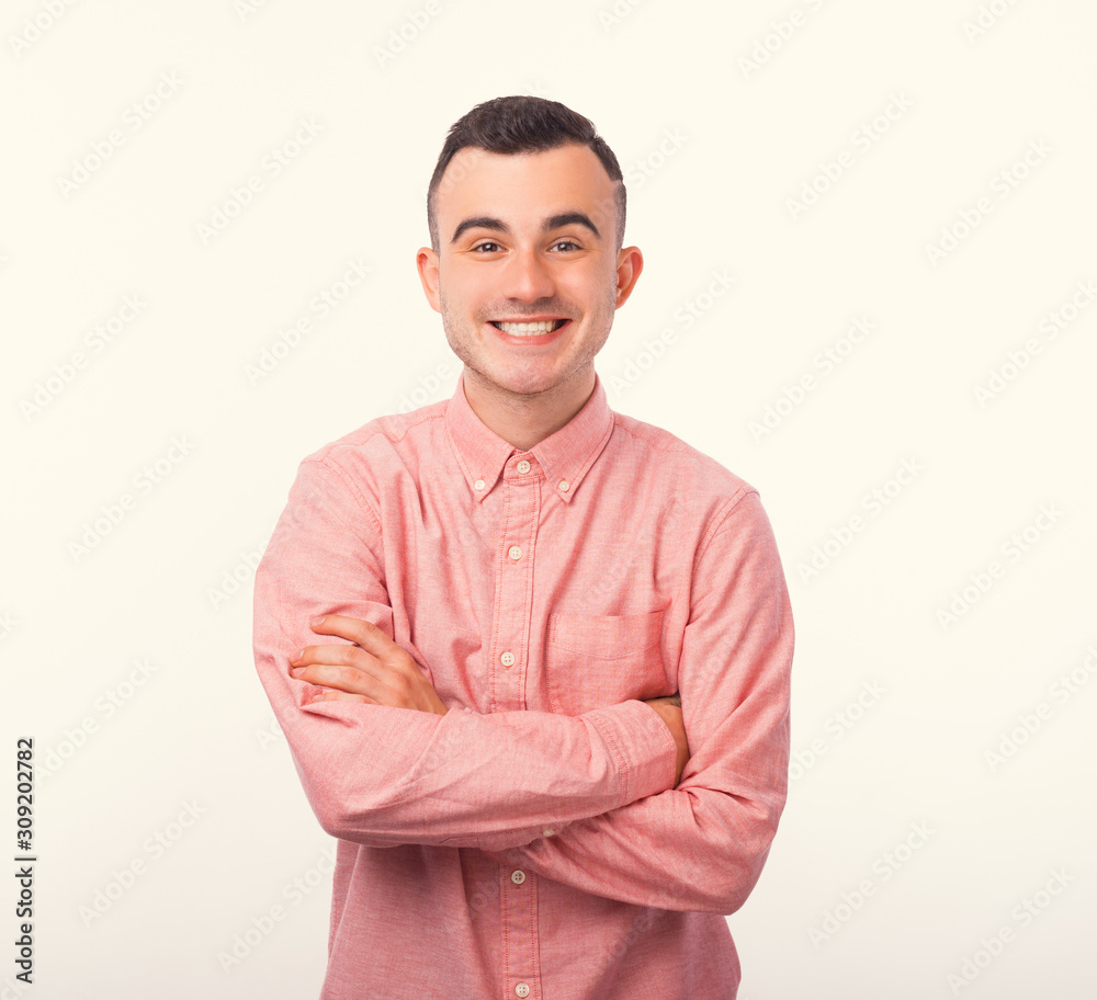 Portrait of smiling man with crossed arms standing over white background Portrait of smiling man with crossed arms standing over white background