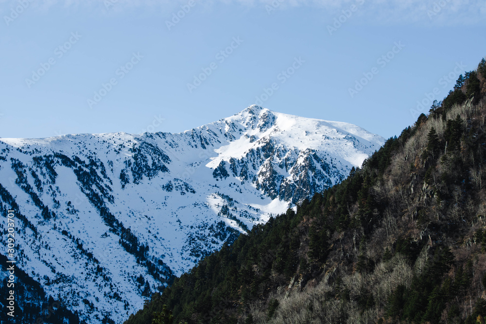 Andorra valley with snowy pyrenees mountains on a sunny day