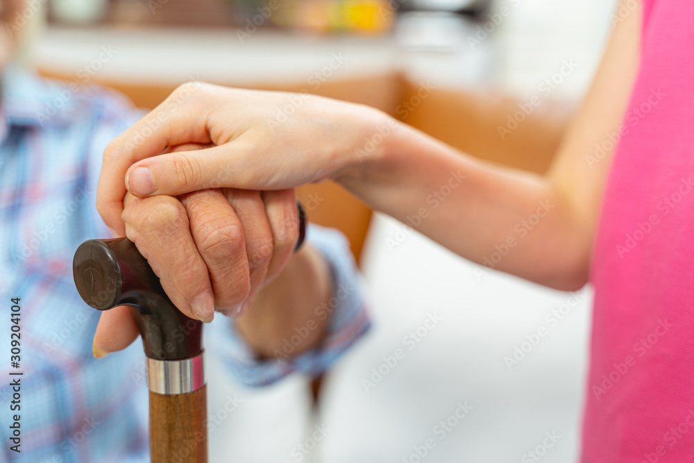 Young female hand touching a pensioner hand