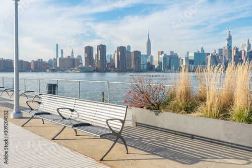 Empty Bench with Plants at a Park in Greenpoint Brooklyn New York looking out towards the East River and the Manhattan Skyline photo