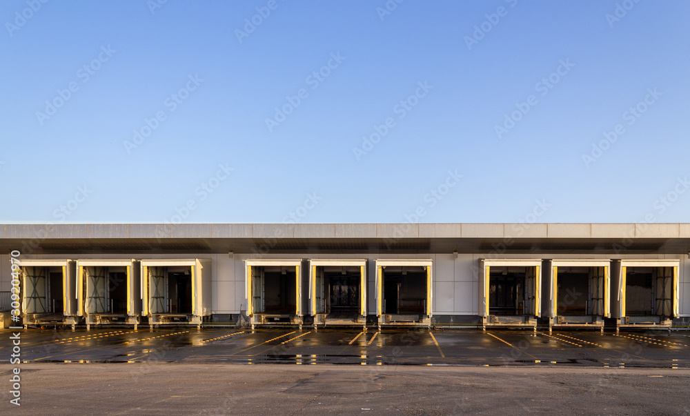 Logistic warehouse truck loading gates. Distribution warehouse building doors Logistic warehouse truck loading gates. Distribution warehouse building doors