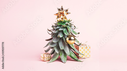 Pineapple leaves in the form of a Christmas tree with decorations. Creative christmas concept. 2020 year