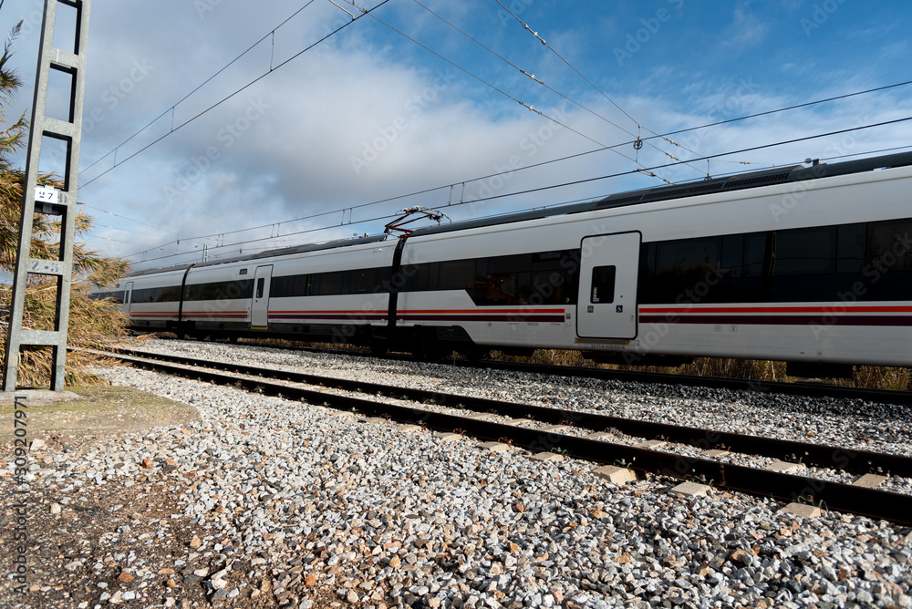 Medium distance train, passing through an abandoned station in Toledo, Spain Medium distance train, passing through an abandoned station in Toledo, Spain