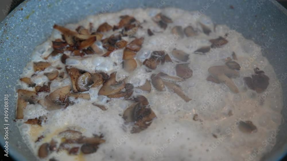 Creamy mushroom sauce boiling in the pan Creamy mushroom sauce boiling in the pan