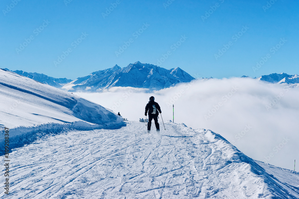 Man Skier skiing in Zillertal Arena ski resort in Austria