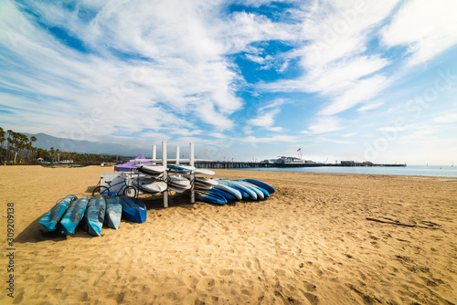 Bike, kayaks and surfboards in Santa Barbara shore photo