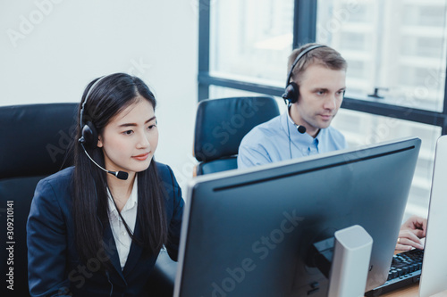 Group of diverse telemarketing customer service staff team in call center.