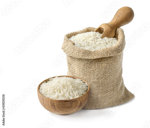 Dry white long rice basmati in wooden bowl and burlap sack with wooden scoop isolated on white background.