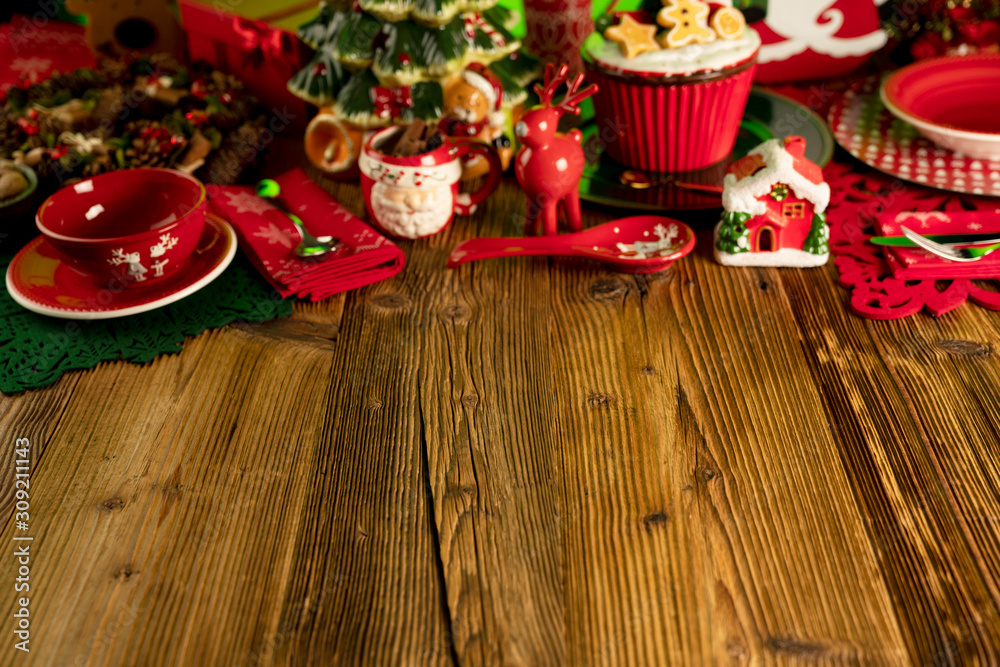 Christmas time. Christmas tableware and decorations. Red and brown colors. Rustic wooden background. Christmas time. Christmas tableware and decorations. Red and brown colors. Rustic wooden background.