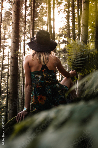 Young woman  holding ferns ...