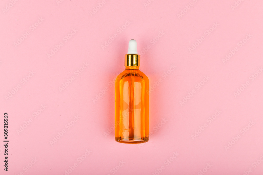 effective can of oil on a pink background. Eco care concept. Skin care products. craft paper. The apartment was lying. Golden oil in a dropper. Pure hemp oil with a bright golden color in a dropper on