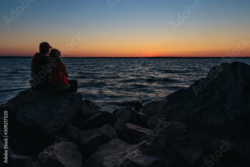 Couple sitting on the stones and hugging each other