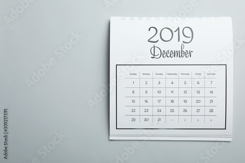 December 2019 calendar on light grey background, top view. Space for text